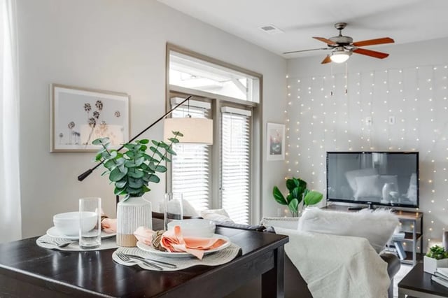 Dining table set with plant and lights living room at The James Apartments Richmond in Richmond Student Accommodation