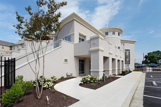 Modern beige building with curved elements exterior at The James Apartments Richmond in Richmond Student Accommodation