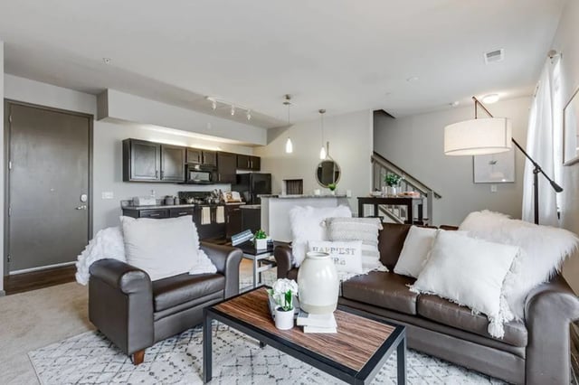 Brown leather couches and armchair kitchen living area at The James Apartments Richmond in Richmond Student Accommodation