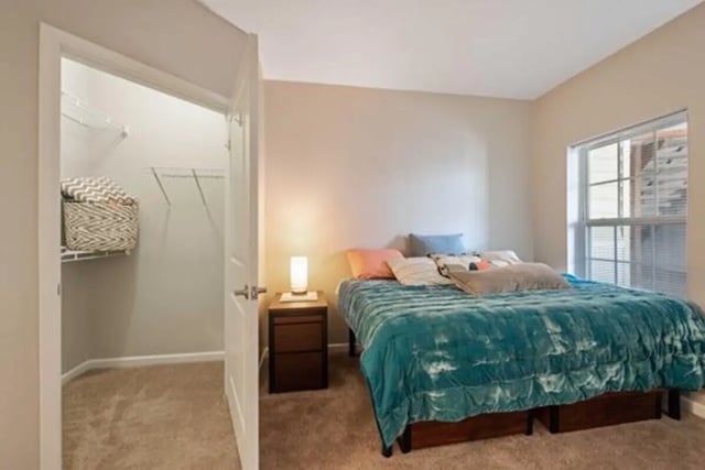 Bed with turquoise comforter open closet bedroom at University Edge-Cincinnati in Cincinnati Student Accommodation
