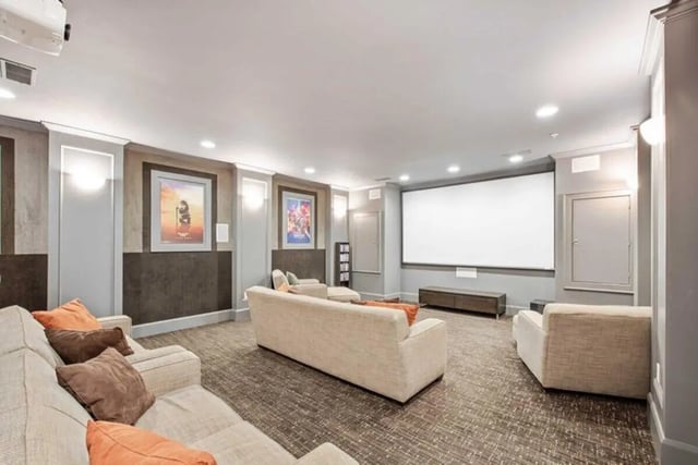 Comfortable couches with pillows movie screen and art living room at University Edge-Cincinnati in Cincinnati Student Accommodation