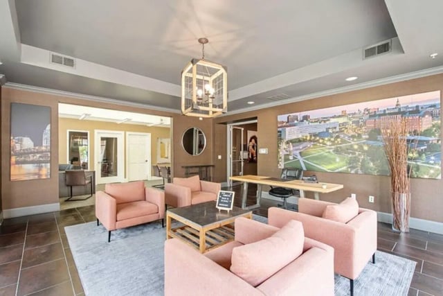 Pink armchairs coffee table large cityscape art living room at University Edge-Cincinnati in Cincinnati Student Accommodation