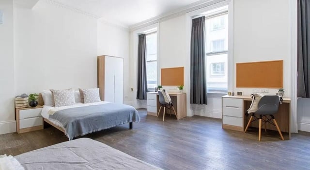 Beds desks wardrobe cork boards student bedroom at Bloomsbury Janet Poole House in London Student Accommodation