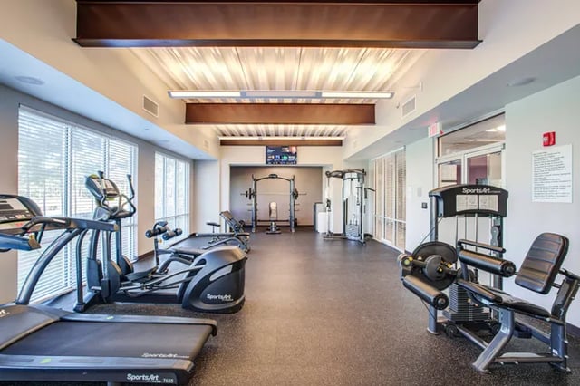 Treadmills ellipticals weight machines gym fitness room at Student Living at Florida Polytechnic University in Lakeland Student Accommodation