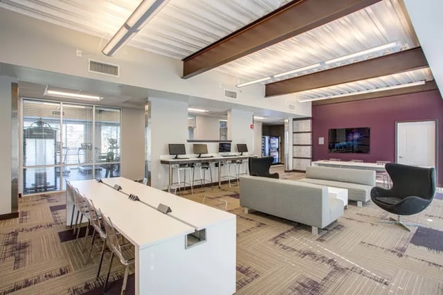 Computers couches and a long table common area at Student Living at Florida Polytechnic University in Lakeland Student Accommodation