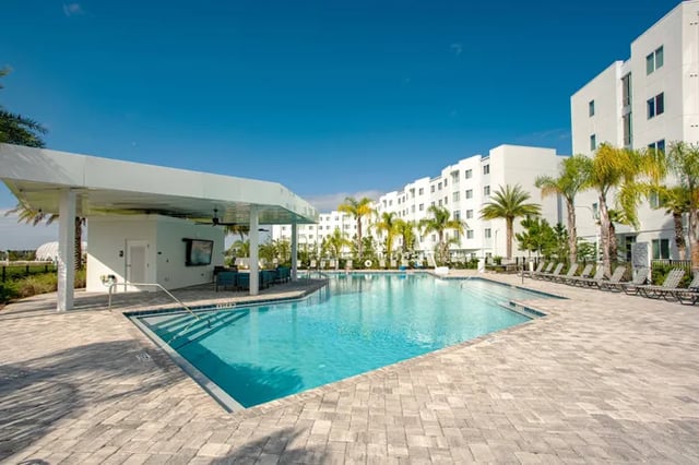 Poolside cabana with seating and lounge chairs exterior at Student Living at Florida Polytechnic University in Lakeland Student Accommodation