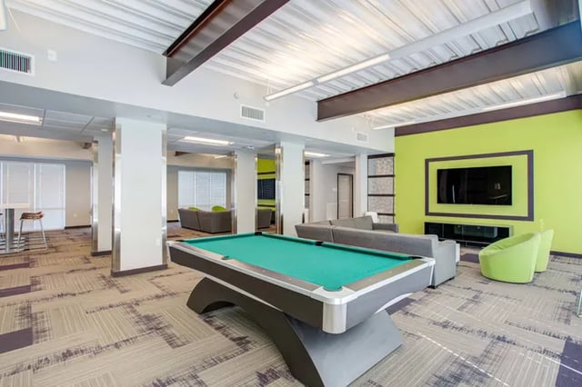 Pool table sofas TV modern common area at Student Living at Florida Polytechnic University in Lakeland Student Accommodation