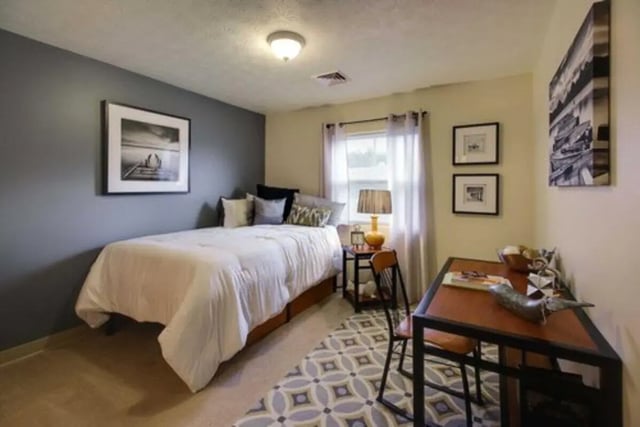 Bed desk lamp and artwork bedroom at West Run in Morgantown Student Accommodation