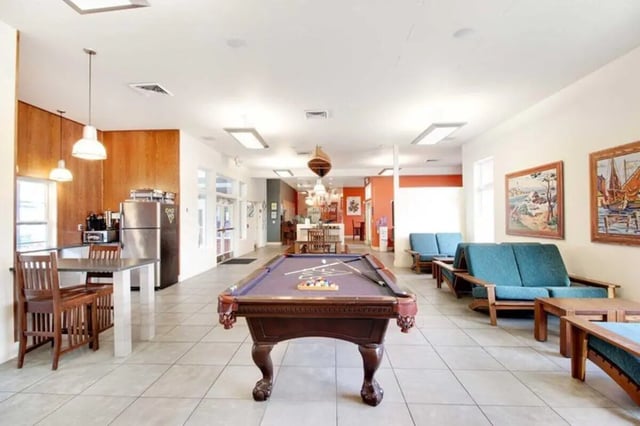 Pool table kitchen and seating area common room at West Run in Morgantown Student Accommodation
