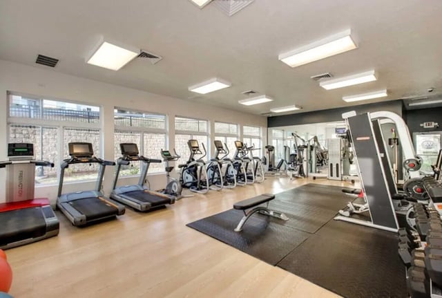 Treadmills elliptical machines weight machines workout gym area at West Run in Morgantown Student Accommodation