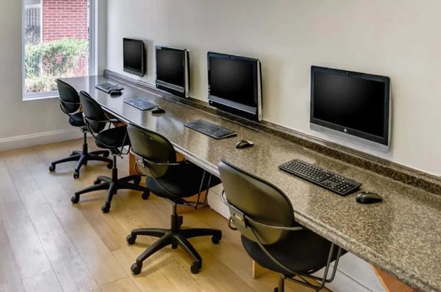 Row of computers and chairs study area at West Run in Morgantown Student Accommodation