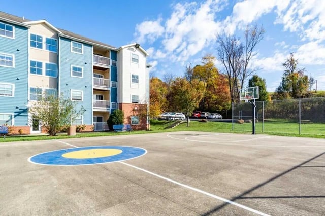 Apartment building with basketball court exterior at West Run in Morgantown Student Accommodation