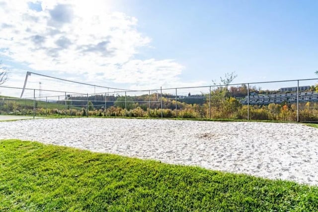 Sand volleyball court with grass and fence playing area at West Run in Morgantown Student Accommodation