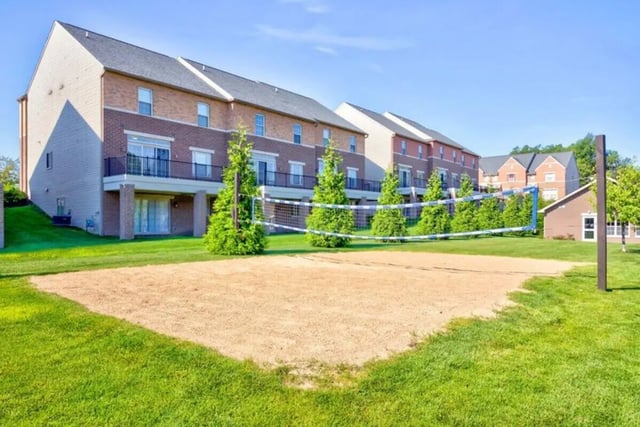 Volleyball court and townhouses exterior at Irish Flats in South Bend Student Accommodation