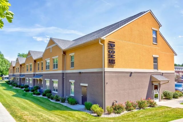 Orange and brick student housing exterior exterior at Irish Flats in South Bend Student Accommodation