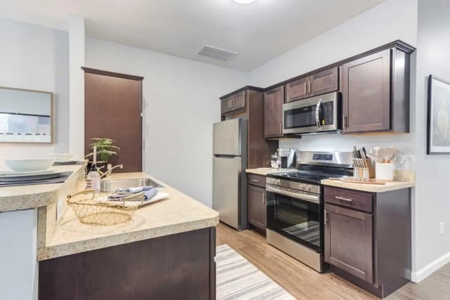 Modern kitchen with dark cabinets stainless steel appliances kitchen at Overlook at Notre Dame in South Bend Student Accommodation