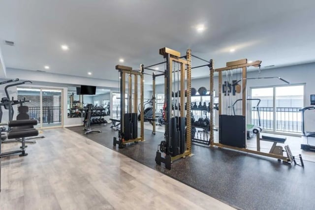 Weight machines and dumbbells in a modern gym. at Overlook at Notre Dame in South Bend Student Accommodation