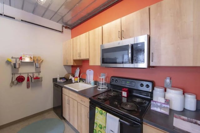 Modern kitchen with microwave sink stove kitchen. at The Abigail in Columbus Student Accommodation