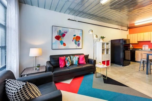 Sofa armchair abstract art rug kitchen living room at The Abigail in Columbus Student Accommodation