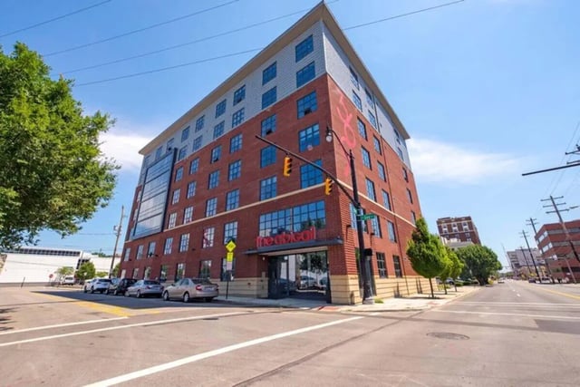 Brick building with windows and cars exterior at The Abigail in Columbus Student Accommodation