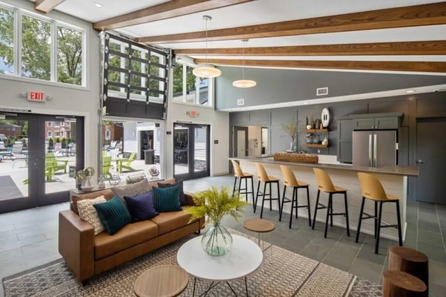 Leather sofa bar stools and kitchen counter area living room at The Flats at Douglas in Toledo Student Accommodation
