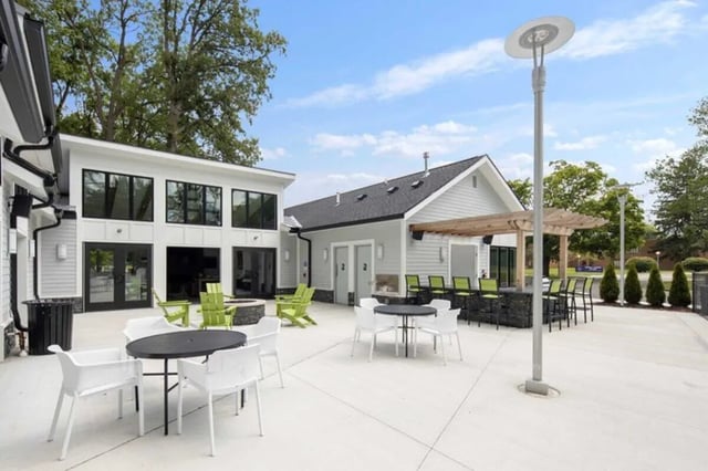 Outdoor seating patio tables chairs bar area exterior at The Flats at Douglas in Toledo Student Accommodation