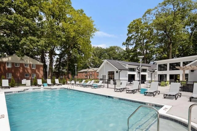 Poolside lounge chairs and swimming pool exterior at The Flats at Douglas in Toledo Student Accommodation
