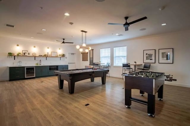 Pool table foosball table with wet bar living room at The Outpost Fort Collins in Fort Collins Student Accommodation