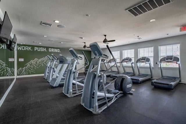 Treadmills and ellipticals in a gym. Gym at The Outpost Fort Collins in Fort Collins Student Accommodation