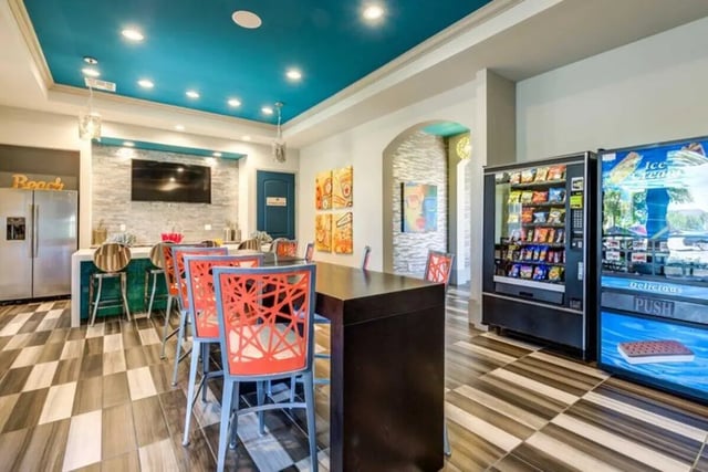 Vending machines chairs and a TV common area at The Reef in Fort Myers Student Accommodation