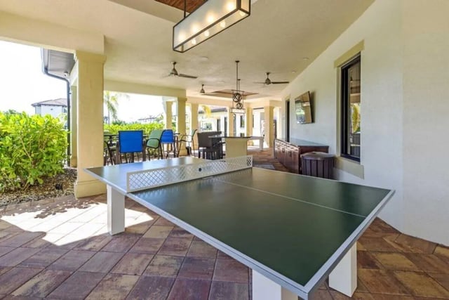 Ping pong table seating dining tables entertainment area outdoor at The Reef in Fort Myers Student Accommodation