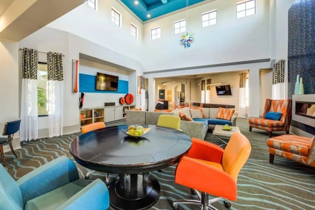 Colorful seating area with round table living room at The Reef in Fort Myers Student Accommodation