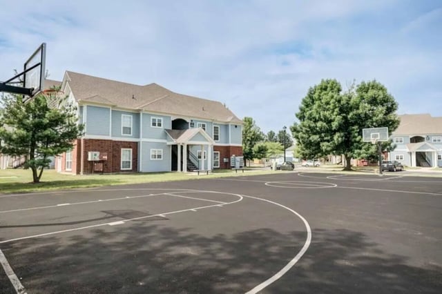 Basketball court next to apartment buildings exterior at The Lodge on the Trail in West Lafayette Student Accommodation