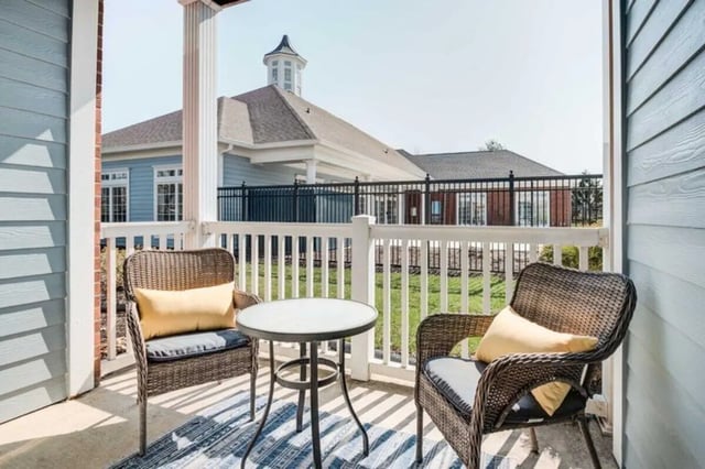 Two wicker chairs and table exterior at The Lodge on the Trail in West Lafayette Student Accommodation