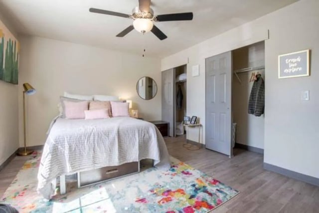 Bed with pink pillows under ceiling fan bedroom at Terrace View in Blacksburg Student Accommodation