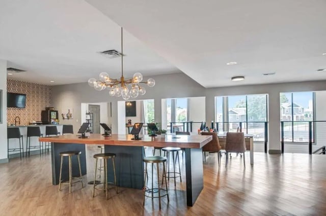 Large table with bar stools and tablets lounge at Terrace View in Blacksburg Student Accommodation