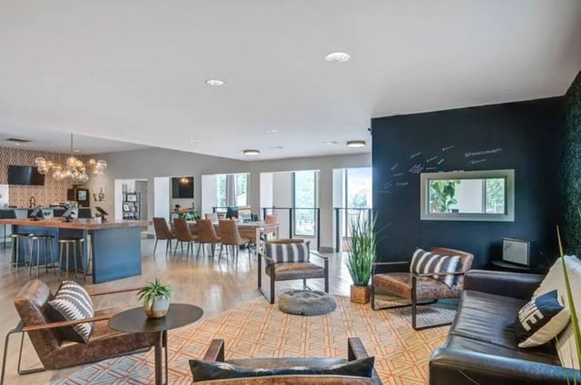 Leather sofas chairs tables and bar with seating living area at Terrace View in Blacksburg Student Accommodation