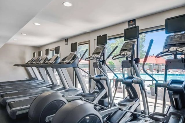 Treadmills and ellipticals with screens gym at Terrace View in Blacksburg Student Accommodation