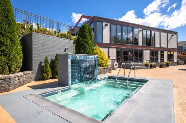 Hot tub with waterfall and modern building exterior at Terrace View in Blacksburg Student Accommodation