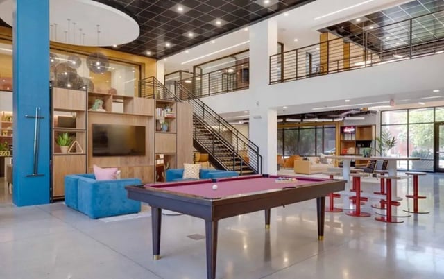 Pool table blue sofas entertainment center living area at Nine 20 Tempe in Tempe Student Accommodation