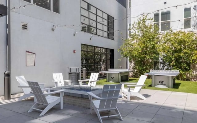 White Adirondack chairs around fire pit exterior at Nine 20 Tempe in Tempe Student Accommodation