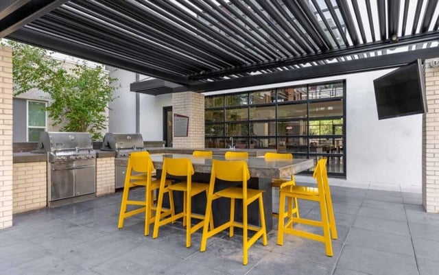 Two grills counter yellow chairs outdoor kitchen at Nine 20 Tempe in Tempe Student Accommodation