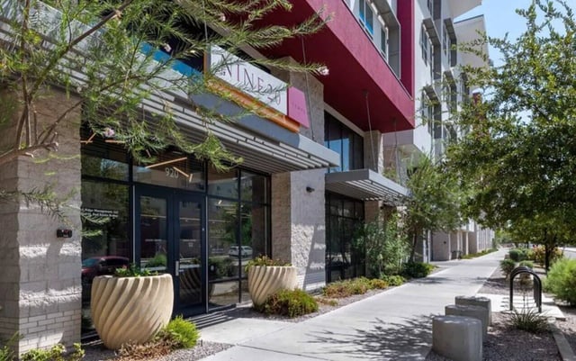 Modern building entrance with large planters exterior at Nine 20 Tempe in Tempe Student Accommodation