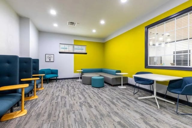 Study area with blue chairs and tables Living room at The Village of Meadowview in Boone Student Accommodation