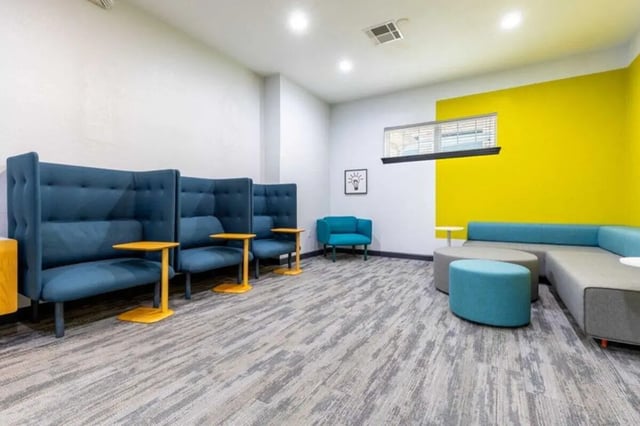 Blue booth seating with yellow tables communal area at The Village of Meadowview in Boone Student Accommodation