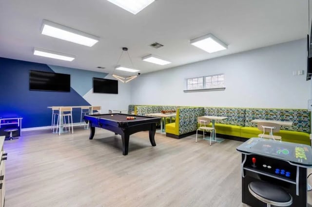 Pool table arcade cabinet lounge seating area playing area at The Village of Meadowview in Boone Student Accommodation
