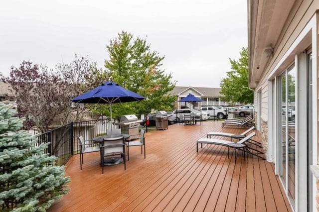Grills chairs table umbrellas lounge chairs outdoor area at The Village of Meadowview in Boone Student Accommodation
