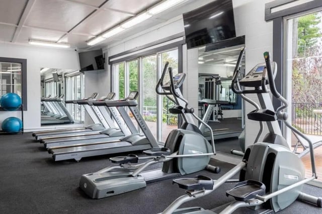 Treadmills elliptical machines and blue exercise balls gym at The Village of Meadowview in Boone Student Accommodation