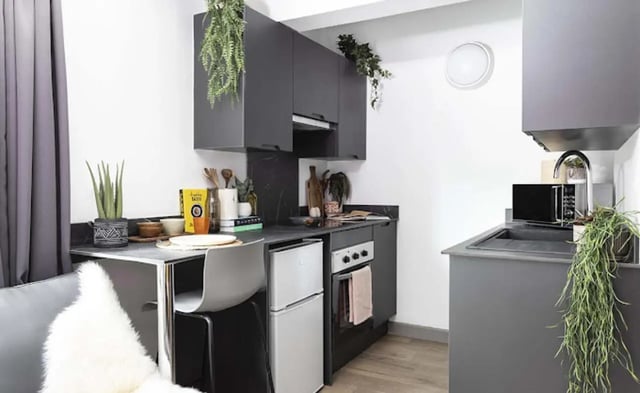 Compact kitchen with microwave mini-fridge stove kitchen at New Medlock House in Manchester Student Accommodation