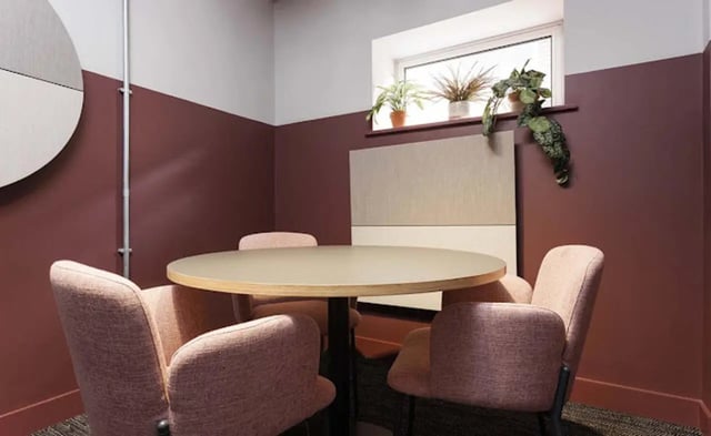 Round table four pink chairs plants study area at New Medlock House in Manchester Student Accommodation
